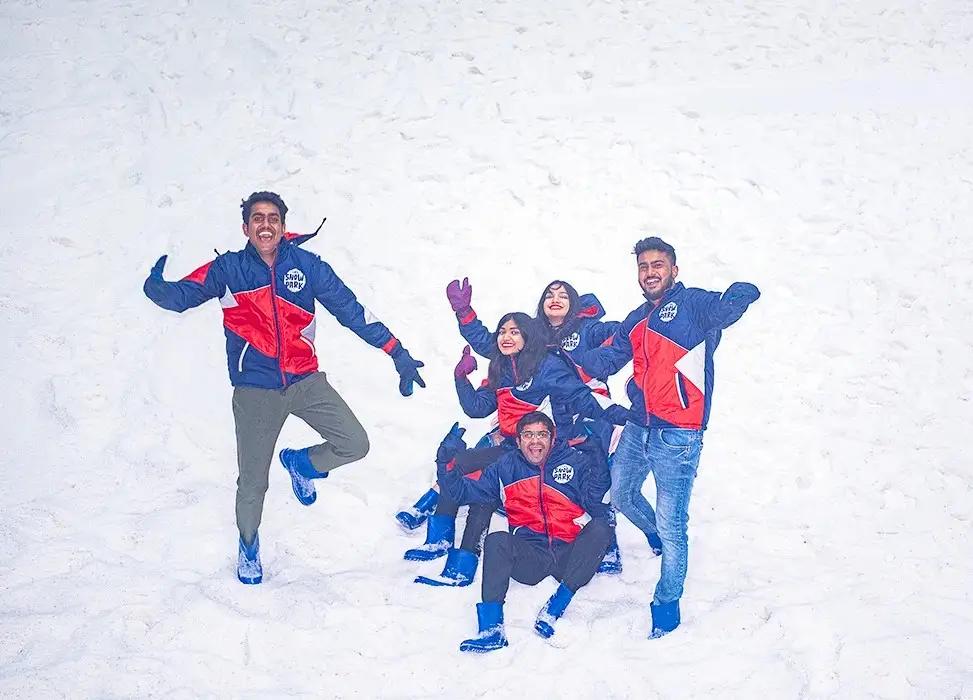 Friends jumping in snow at GRS Snow Park